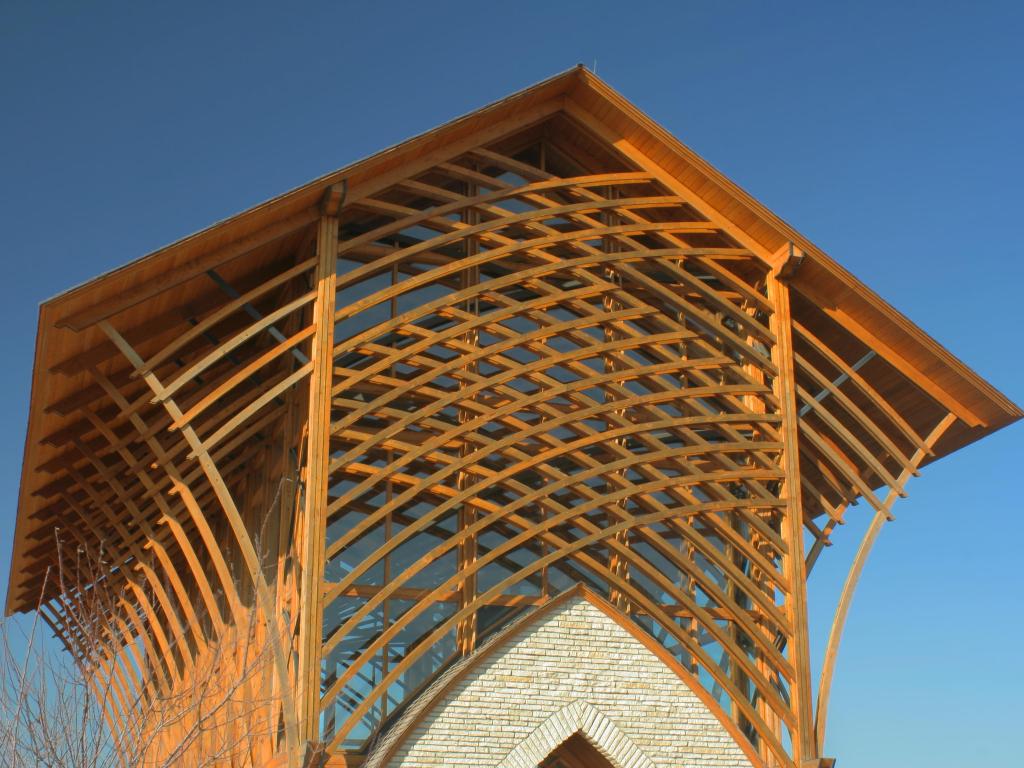 Distinctive wooden-roofed structure of the Holy Family Shrine, Omaha, Nebraska, with a blue sky above