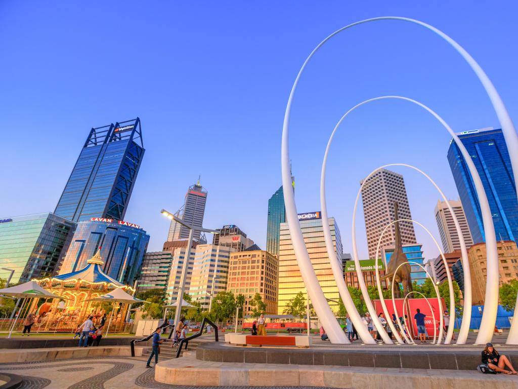 Famous landmarks in Perth Downtown: Esplanade, skyscrapers of Central Business District, Elizabeth Quay Carousel and Spanda Sculpture in Elizabeth Quay. Sunset light.
