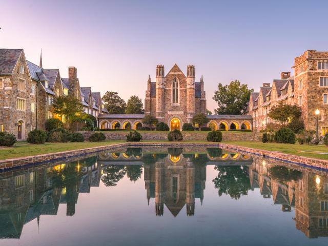Historic campus with a pool in the front during twilight hours