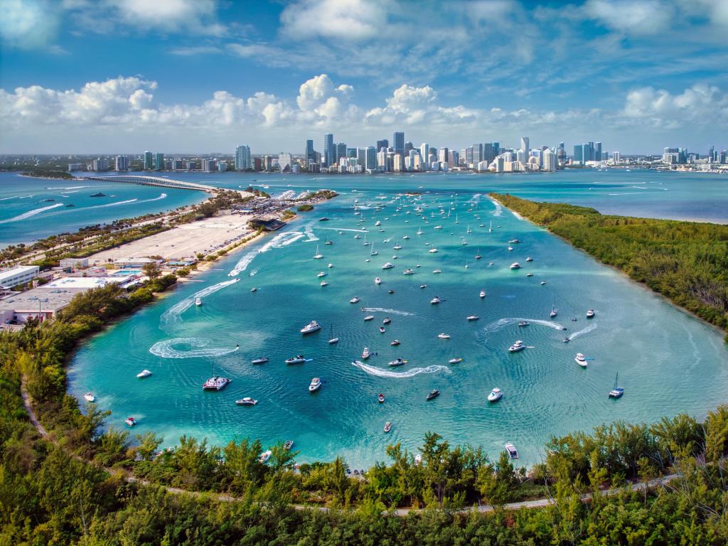 Biscayne Bay, Miami with an aerial view the boats in the bay in the foreground and the and Miami Skyline in the distance. 