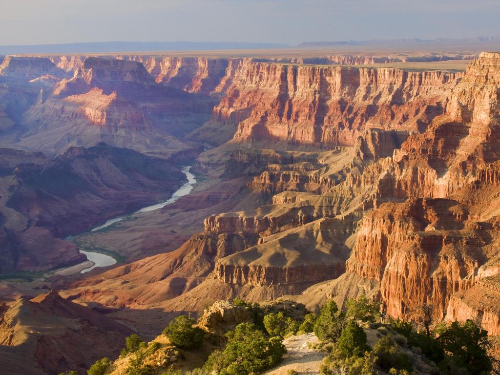 View of Grand Canyon from Desert Viewpoint with river running at the bottom of the canyon and steep cliffs
