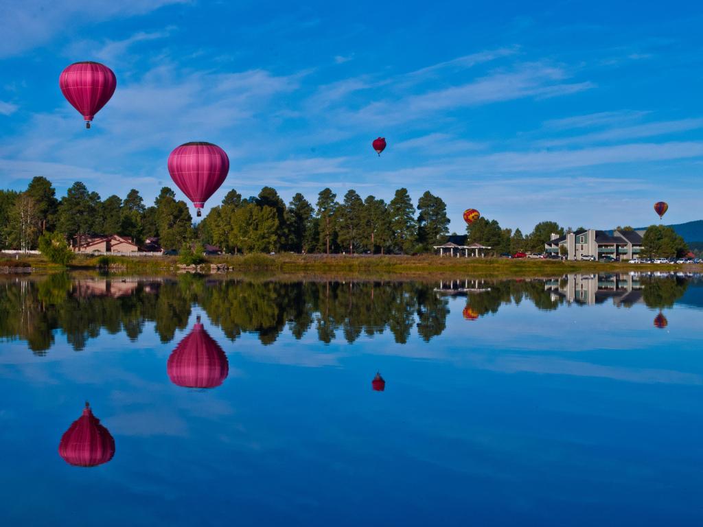 Hot air balloon festival in Pagosa Springs Colorado, with colorful balloons all over the morning sky