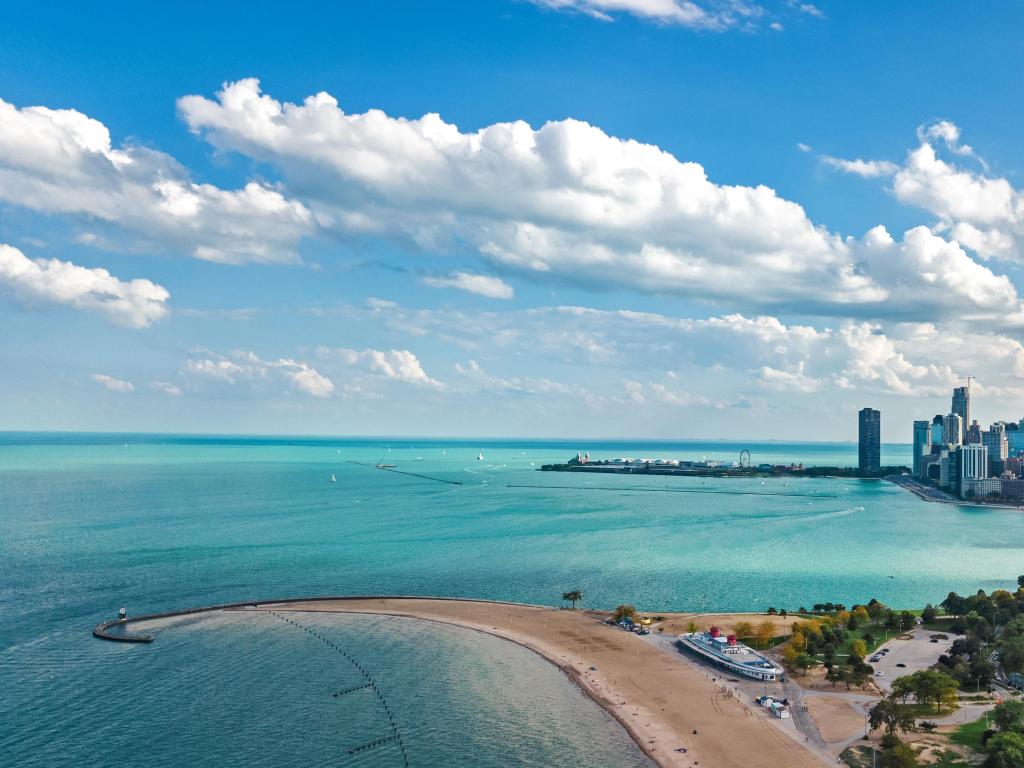 Lake Michigan, Illinois, USA and city of Chicago with downtown skyscrapers in the background and the sea in the foreground, taken from aerial view.