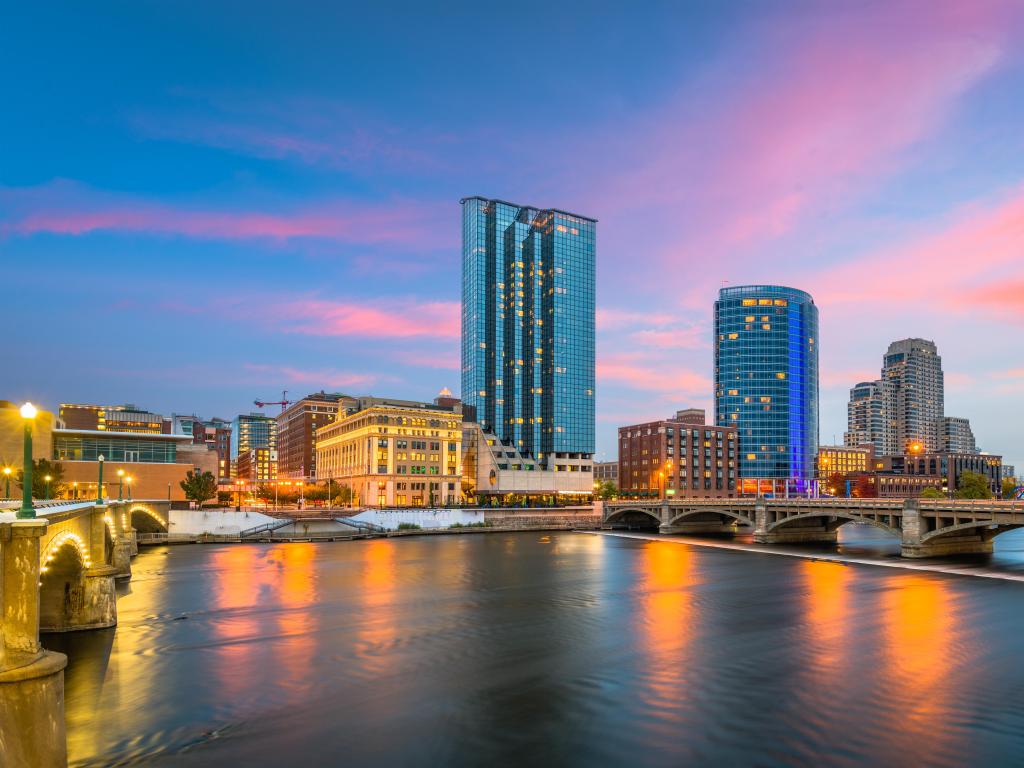 Grand Rapids, Michigan, USA downtown skyline on the Grand River at dusk.