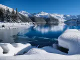 Winter lake with reflections of mountains in calm water. Garibaldi Lake in Whistler. British Columbia. Canada