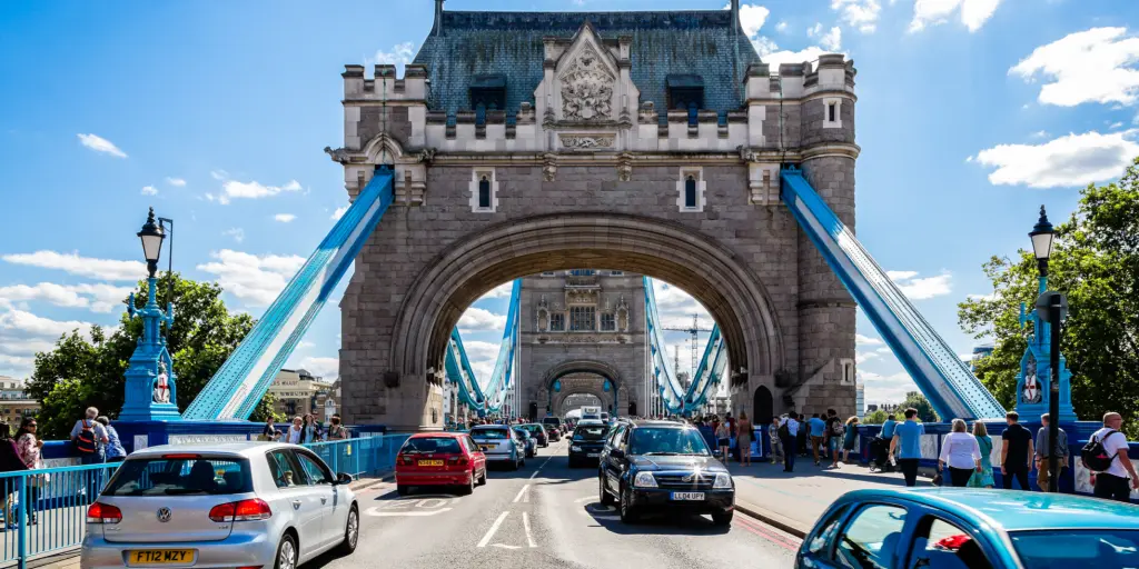 Cars drive on the left side of the road over Tower Bridge in London