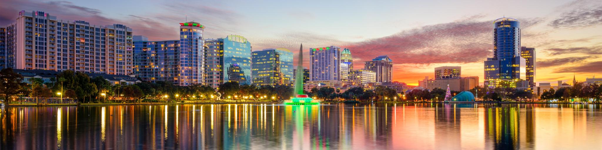 Orlando, Florida, USA downtown city skyline on Eola Lake taken at early evening.