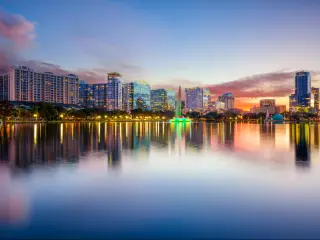 Orlando, Florida, USA downtown city skyline on Eola Lake taken at early evening.