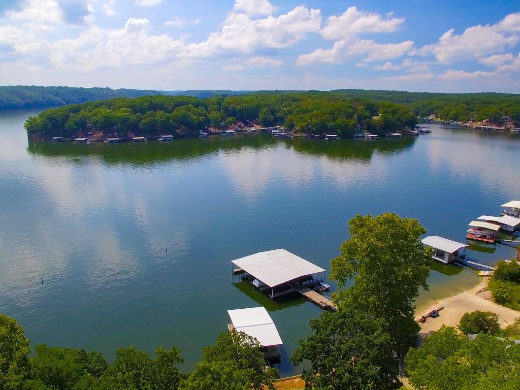 Blue sky with clouds reflecting on Lake of the Ozarks Missouri with docks on a summer day