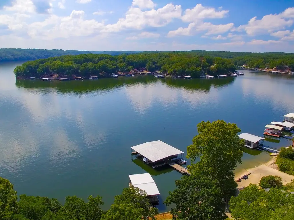 Blue sky with clouds reflecting on Lake of the Ozarks Missouri with docks on a summer day
