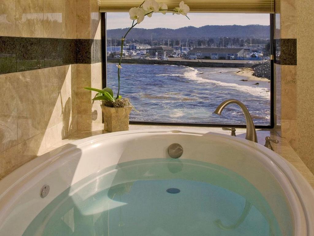 View of Monterey Bay through glass window from the bathtub at Monterey Bay Inn