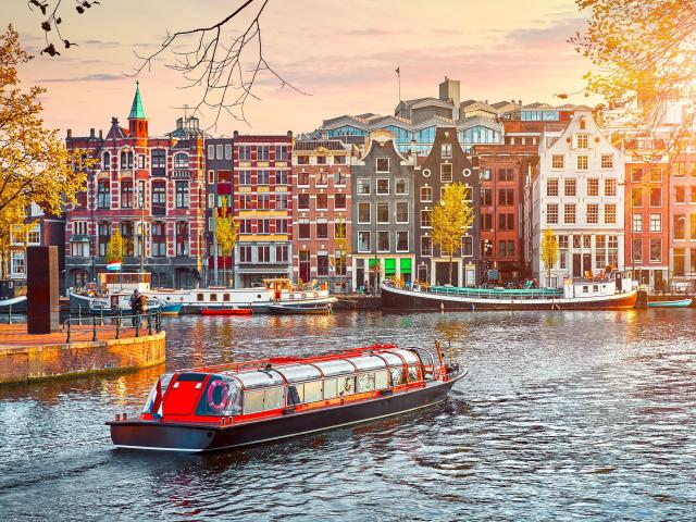 Channel in Amsterdam Netherlands houses river Amstel landmark old European city spring landscape.