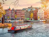 Channel in Amsterdam Netherlands houses river Amstel landmark old European city spring landscape.