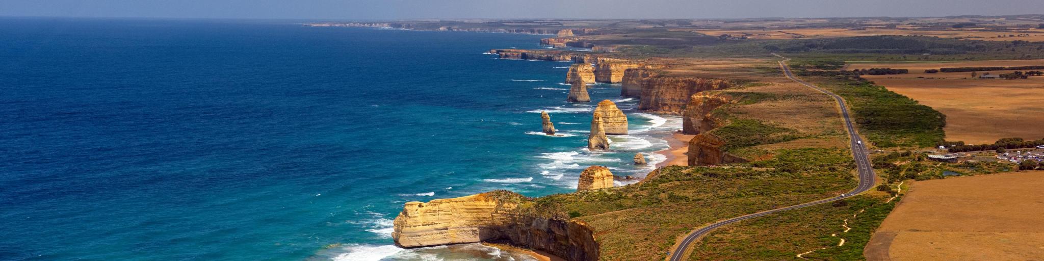 Aerial view across the Great Ocean Road and 12 Apostles against striking coastline, Australia