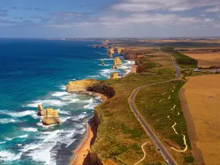 Aerial view across the Great Ocean Road and 12 Apostles against striking coastline, Australia