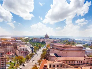 Washington DC, USA with a view of Pennsylvania Avenue and United States Capitol Building towards USA Congress on National Mall on a sunny day.