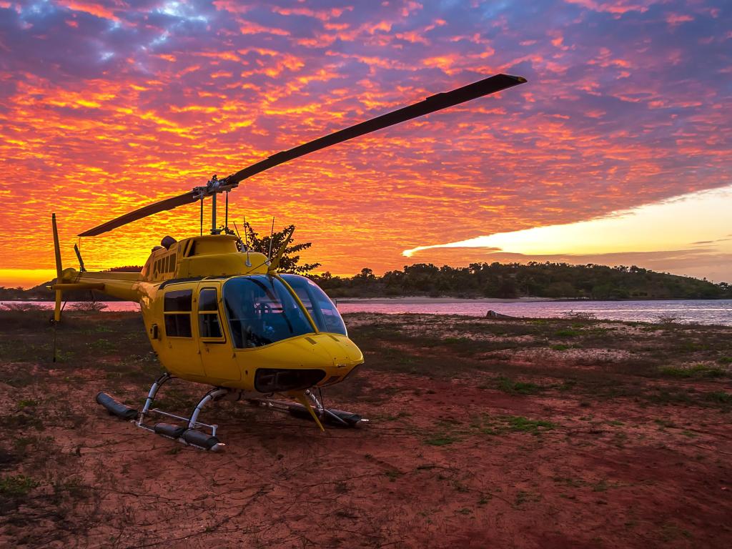 A Helicopter on the a beach at sunset in Cape York, Australia