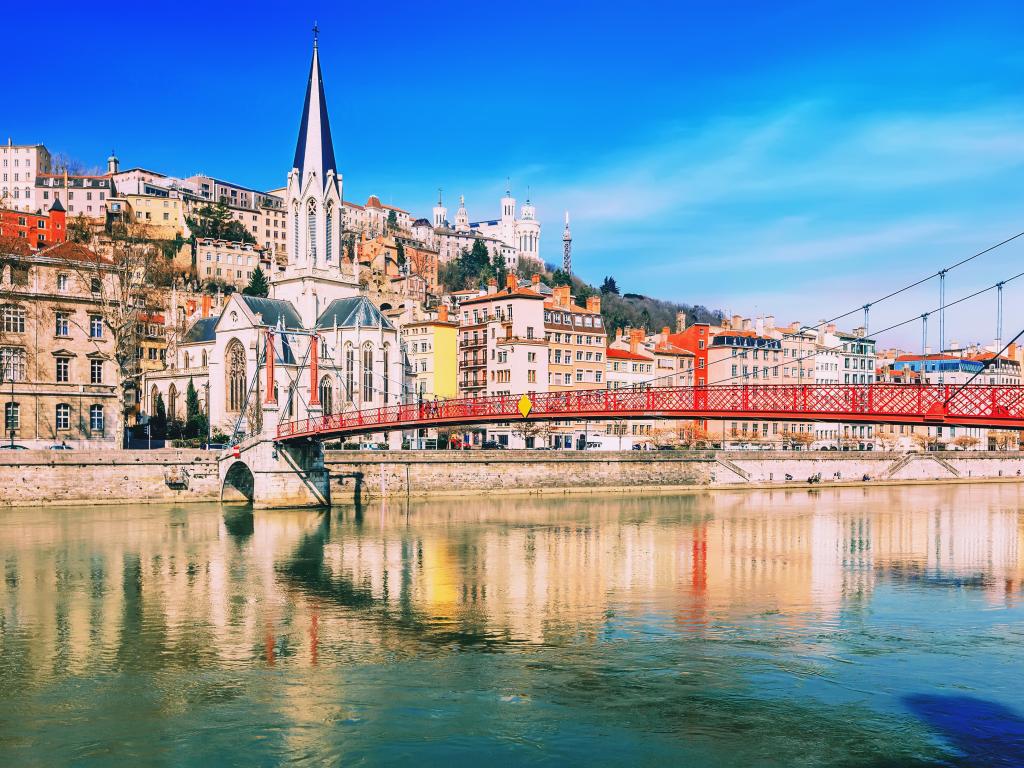 Pedestrian Saint Georges footbridge and the Saint Georges church in Lyon, France in a beautiful spring day
