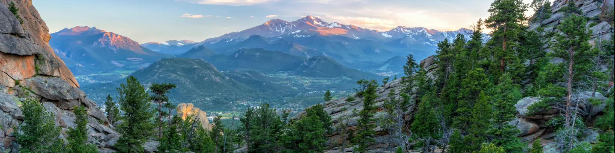 The last evening sunshine hits Longs Peak and The Crags above Gem Lake in Rocky Mountain National Park, Estes Park, Colorado