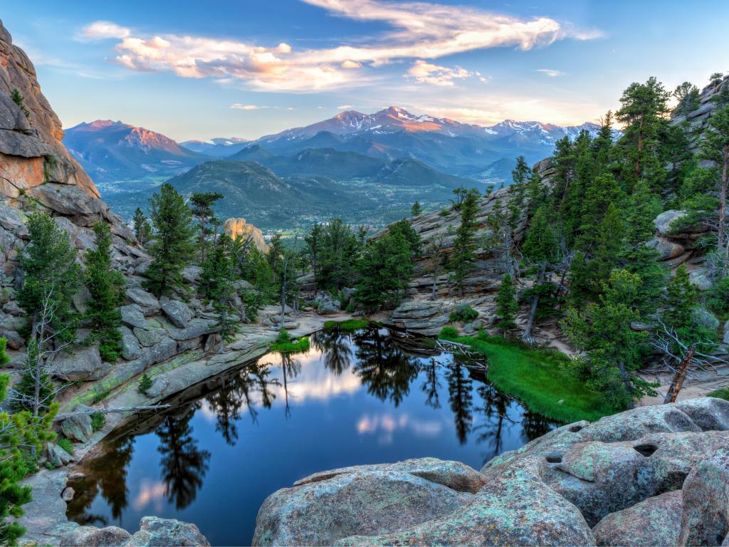 The last evening sunshine hits Longs Peak and The Crags above Gem Lake in Rocky Mountain National Park, Estes Park, Colorado