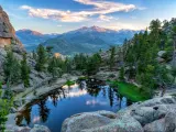 The last evening sunshine hits Longs Peak and The Crags above Gem Lake in Rocky Mountain National Park, Estes Park, Colorado