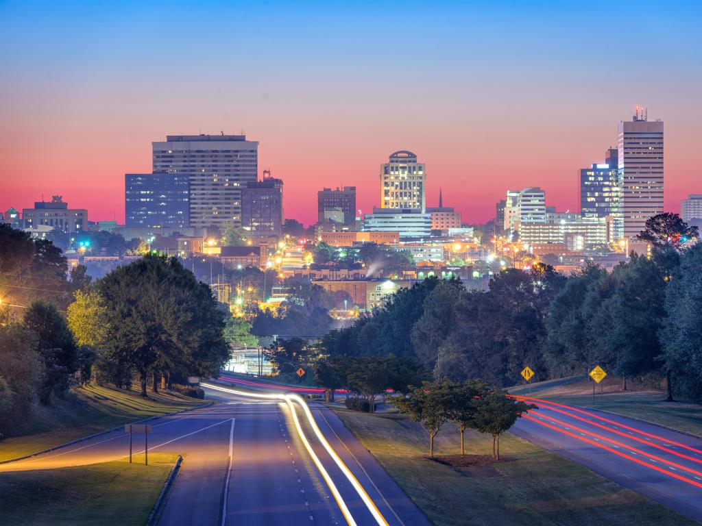 Columbia, South Carolina, USA skyline and highway at sunset.