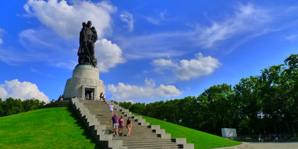 The impressive Soviet Memorial statue sits on a hill in Treptower Park on a sunny day in Berlin