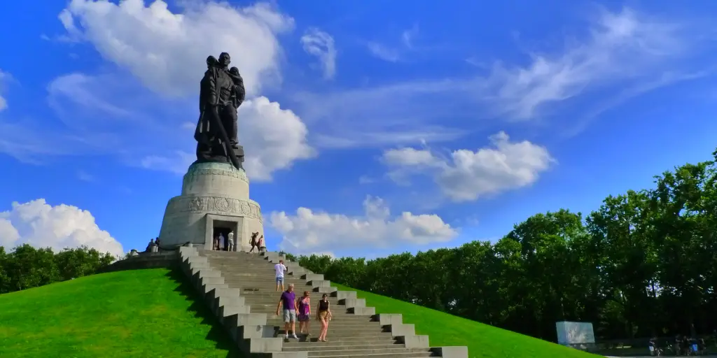 The impressive Soviet Memorial statue sits on a hill in Treptower Park on a sunny day in Berlin