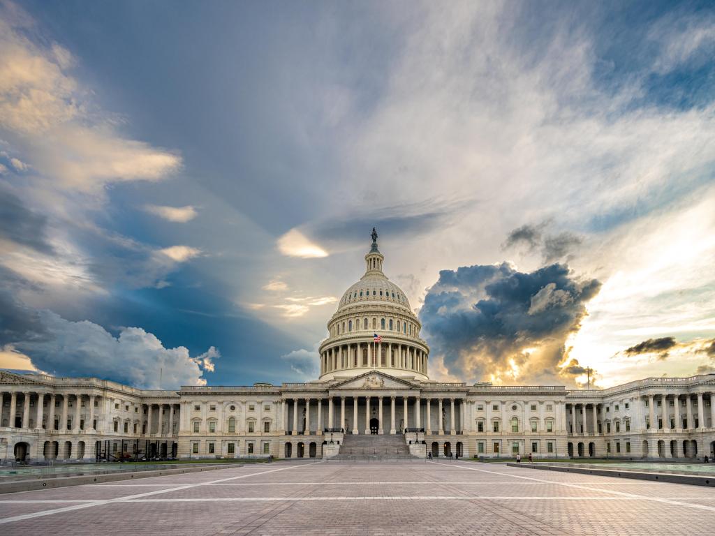 Washington DC, USA with a view of the United States Capitol Building against a cloudy sky.