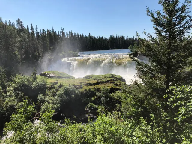 Beautiful waterfalls in a forested area on a sunny day