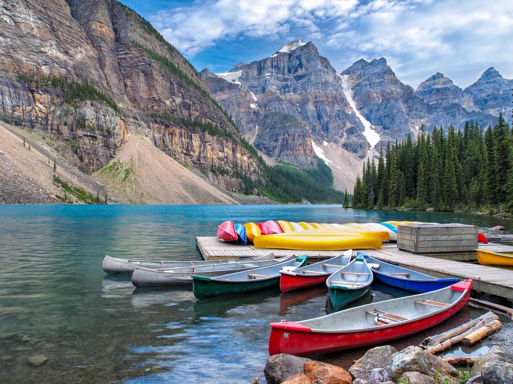 Moraine Lake, Banff National Park, Canada with a beautiful Scene in one of the Rocky Mountain Lakes with a view of canoes on the dock by the lodge.