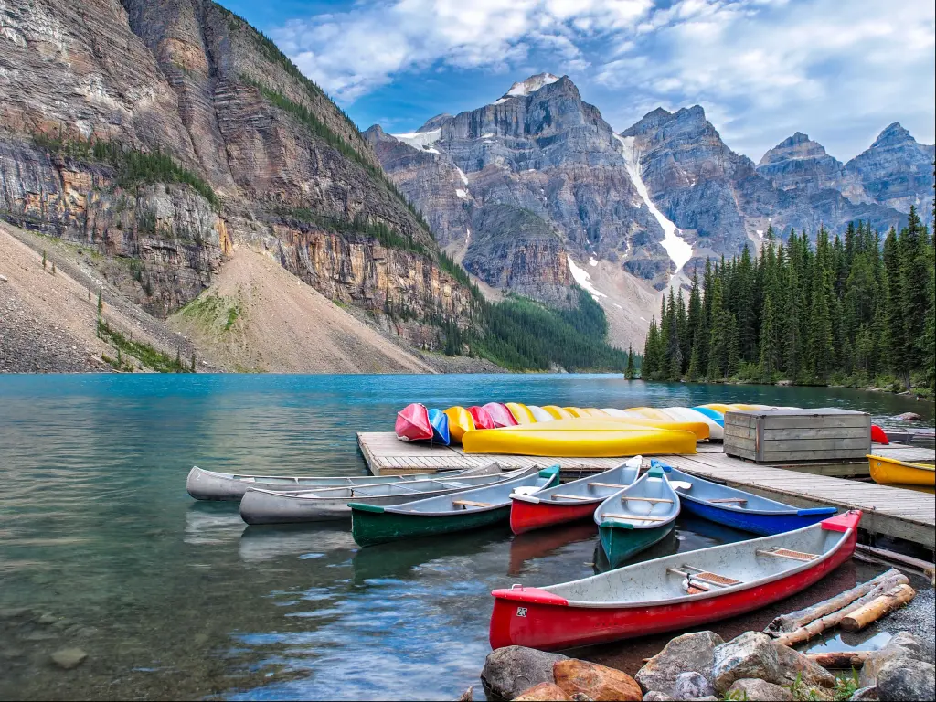 Moraine Lake, Banff National Park, Canada with a beautiful Scene in one of the Rocky Mountain Lakes with a view of canoes on the dock by the lodge.