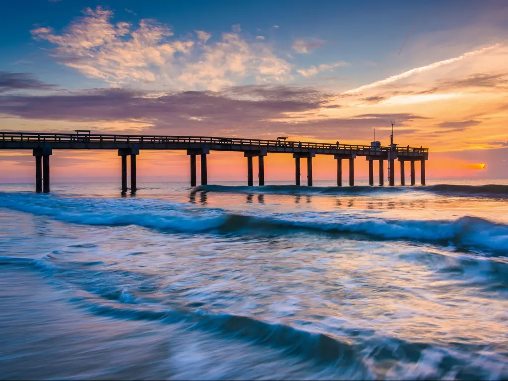 Waves on the Atlantic Ocean and fishing pier at sunrise, St. Augustine Beach, Florida.