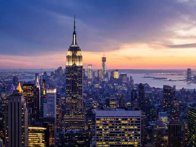 Manhattan, New York City skyline at night, with the Empire State Building in the center and the Hudson River beyond