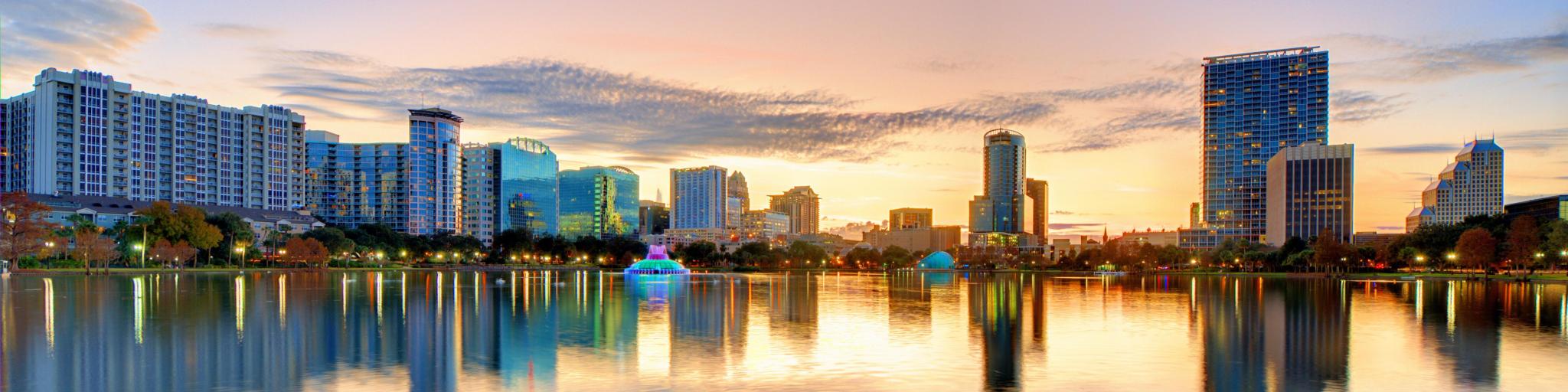 Orlando, Florida, USA with a view of the skyline of Orlando taken from lake Eola at sunset.