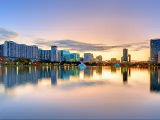 Orlando, Florida, USA with a view of the skyline of Orlando taken from lake Eola at sunset.
