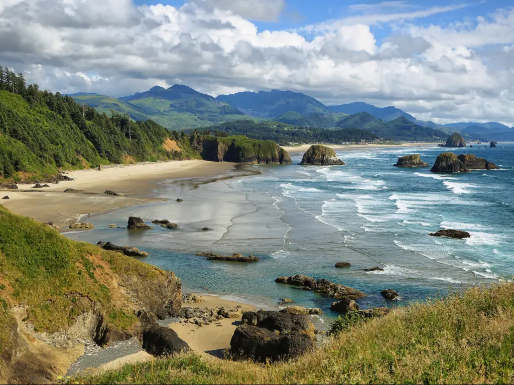 Cannon Beach and Indian Beach in Oregon with rocks standing in the water just off the coast.