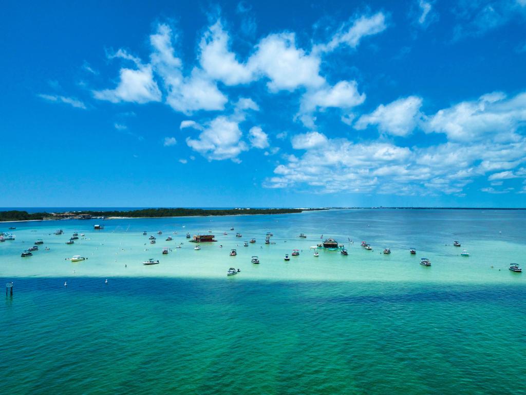 Aerial view of bright blue sea with small boats at Destin, Florida