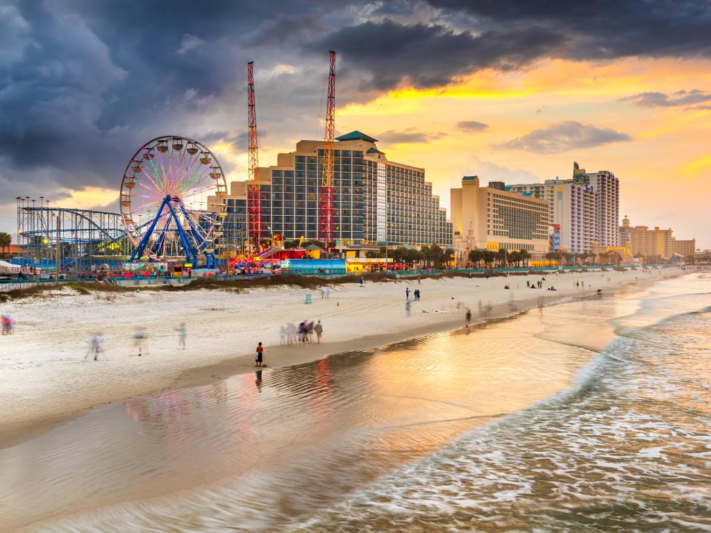 Daytona Beach with high rise buildings and ferris wheel at sunset