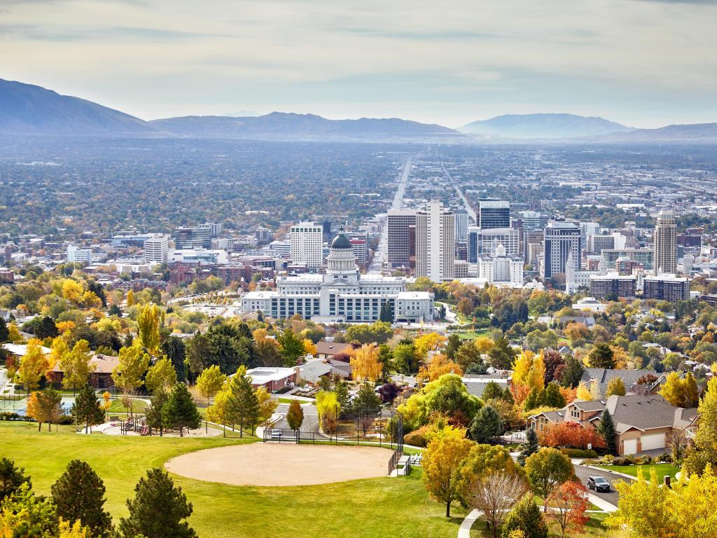 Salt Lake City, Utah, USA taken as an aerial view in autumn with mountains in the distance.