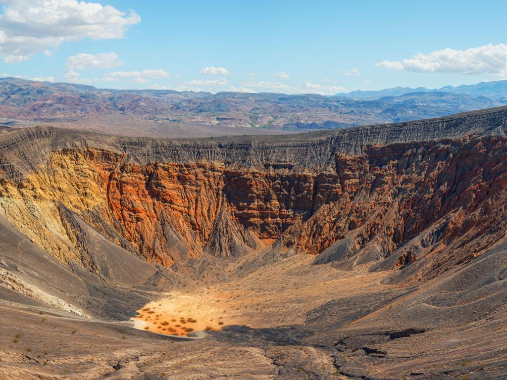 Ubehebe Crater, Death Valley National Park, California, USA with a panorama of the volcanic landscape against a blue sky.