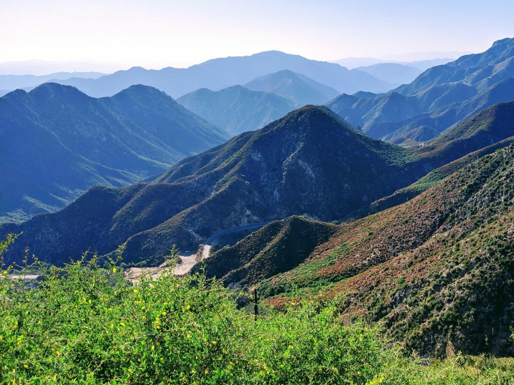 Angeles National Forest, California, USA from Strawberry Peak Trail overlooking the green mountains into the distance on a sunny clear day.