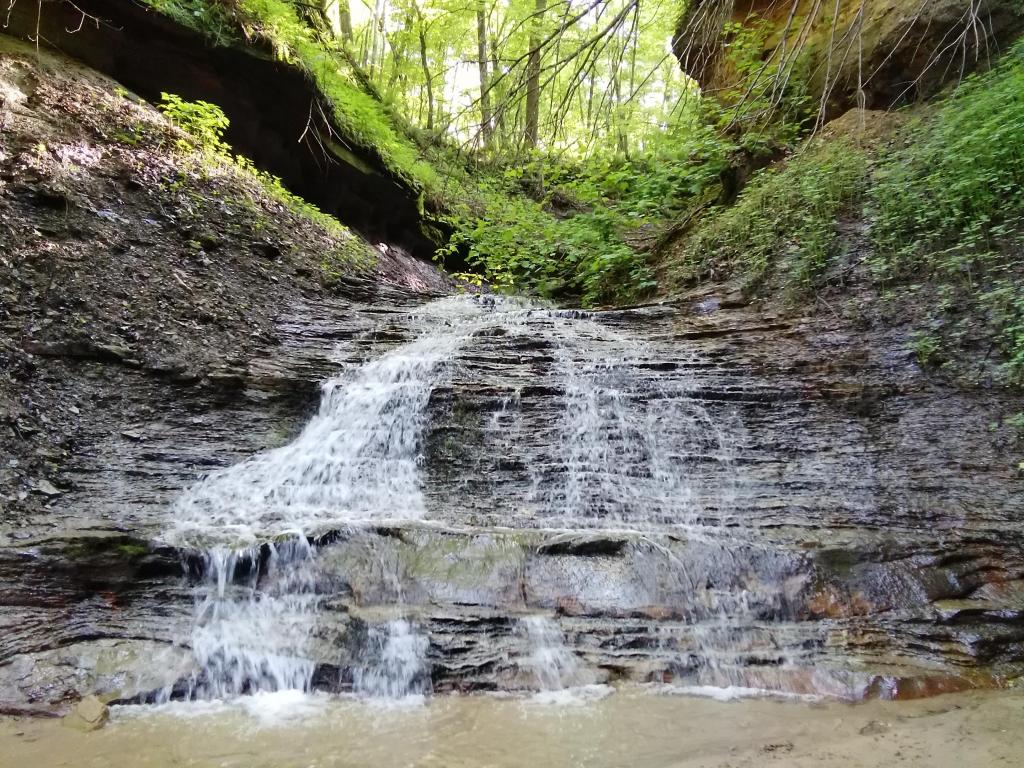 Beautiful waterfall on a stone wall in a forest