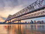 New Orleans, Louisiana, USA at Crescent City Connection Bridge over the Mississippi River at dusk.