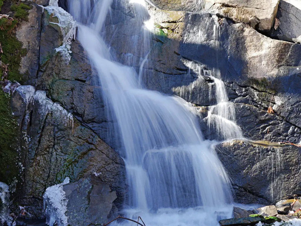Beautiful waterfall, cascading through boulders on a rock wall on its way to the Hudson River