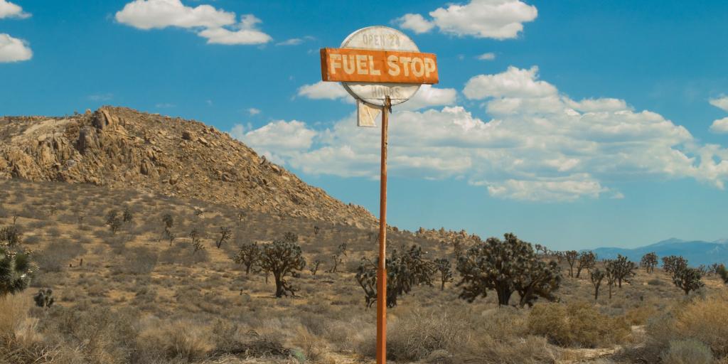 a vintage fuel stop sign in the middle of nowhere 