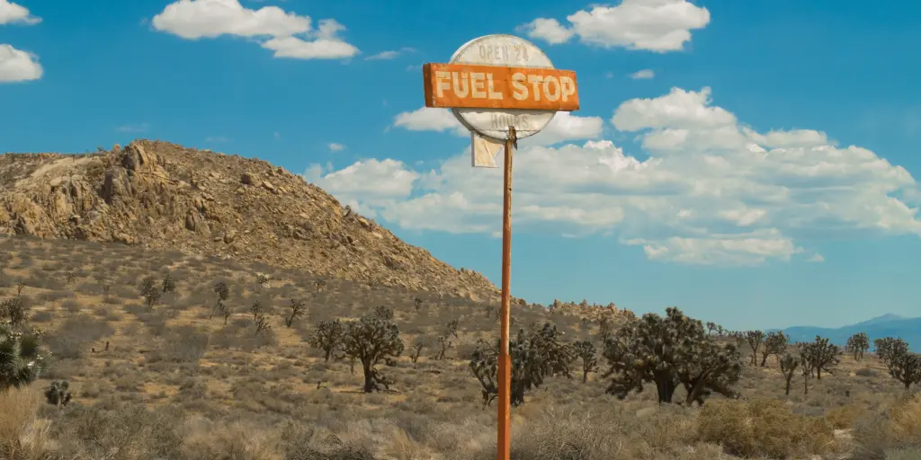 a vintage fuel stop sign in the middle of nowhere 