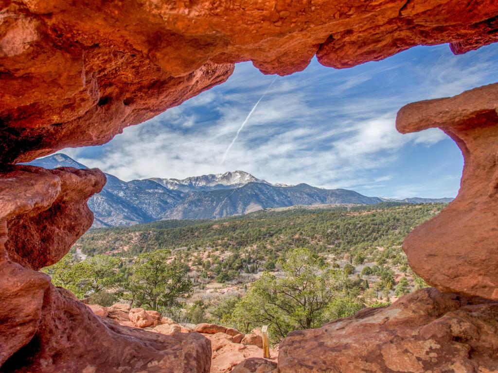 A view of Pikes Peak through a stone viewing point in Colorado Springs.