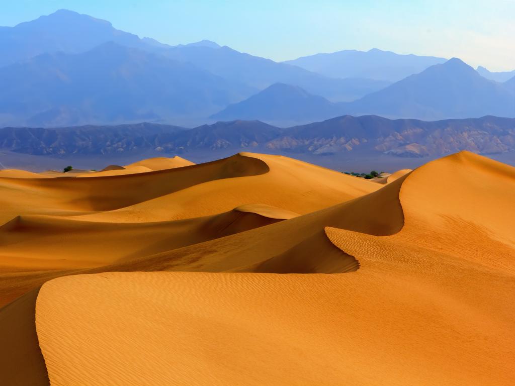 Sand dunes with mountains in the background in Death Valley National Park, California