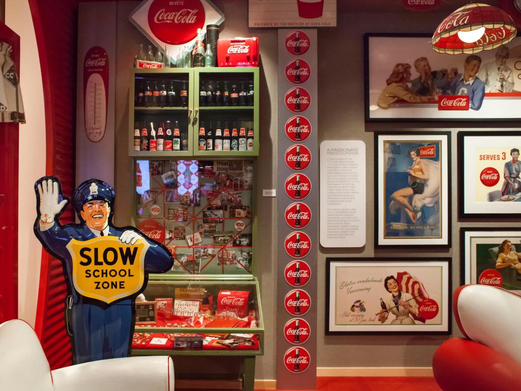 Collection of vintage memorabilia on display in a built living room at the World of Coca-Cola Museum, Atlanta